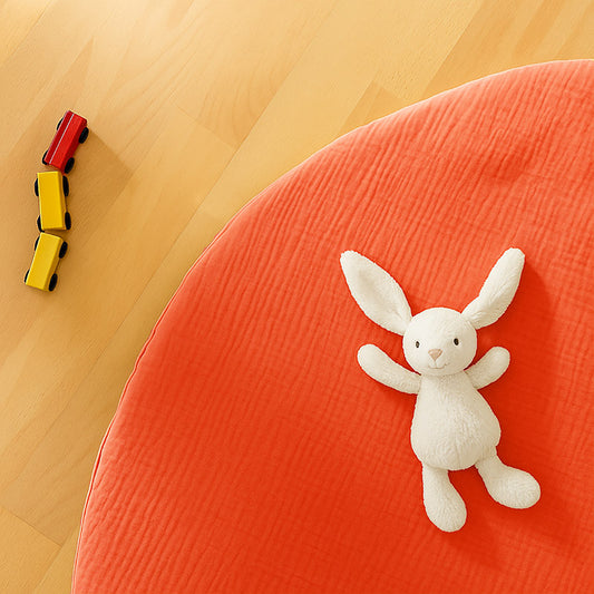 Rundt legetæppe i økologisk bomuld – jordbærfarvet